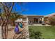 Spacious backyard with lush artificial turf, decorative rock, mature landscaping, and patio area at 30259 N Sunray Dr, San Tan Valley, AZ 85143
