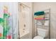 Clean bathroom featuring a shower-tub combination with a cactus curtain and towel storage at 30259 N Sunray Dr, San Tan Valley, AZ 85143