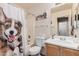 This well-lit bathroom features a shower-tub combo and storage vanity at 30259 N Sunray Dr, San Tan Valley, AZ 85143