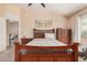 Cozy bedroom showcases wooden furniture and decor, brightened by natural light from a window at 30259 N Sunray Dr, San Tan Valley, AZ 85143