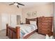 Comfortable bedroom features wood furniture, a ceiling fan, and tasteful wall art at 30259 N Sunray Dr, San Tan Valley, AZ 85143