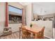 Cozy dining area with wood floors, large window, and views into the kitchen, great for Gathering meals at 30259 N Sunray Dr, San Tan Valley, AZ 85143
