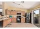 Functional kitchen featuring essential appliances, ample cabinets, and sliding glass door to outdoor space at 30259 N Sunray Dr, San Tan Valley, AZ 85143