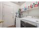 This laundry room features a full-size washer and dryer, shelves and access to the backyard at 30259 N Sunray Dr, San Tan Valley, AZ 85143