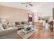 Inviting living room showcasing wood floors, a ceiling fan, and an open-concept layout at 30259 N Sunray Dr, San Tan Valley, AZ 85143