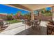 Relaxing covered patio with dining set and seating area, perfect for outdoor entertaining at 30259 N Sunray Dr, San Tan Valley, AZ 85143