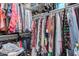 Spacious walk-in closet with clothing racks and shelves filled with clothes and accessories at 30259 N Sunray Dr, San Tan Valley, AZ 85143