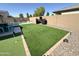 A lush backyard featuring a putting green and barbecue area, perfect for outdoor gatherings at 322 S Soledad Ct, Casa Grande, AZ 85194
