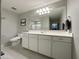 Bathroom featuring a large mirror, white vanity, and neutral color scheme for a clean aesthetic at 322 S Soledad Ct, Casa Grande, AZ 85194