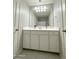 Bright bathroom features a large vanity with storage and a well-lit mirror at 322 S Soledad Ct, Casa Grande, AZ 85194