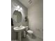 This half bath features a pedestal sink, a toilet, and attractive modern shiplap paneling at 322 S Soledad Ct, Casa Grande, AZ 85194