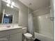Clean and well-lit bathroom featuring a shower and tub combo with a single sink vanity at 322 S Soledad Ct, Casa Grande, AZ 85194