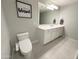 Modern bathroom featuring a spacious vanity, ample lighting, and a toilet for a clean and functional space at 322 S Soledad Ct, Casa Grande, AZ 85194