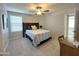 Inviting bedroom with a stylish bed, a ceiling fan, and soft carpet, ensuring a peaceful retreat at 322 S Soledad Ct, Casa Grande, AZ 85194