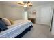Cozy bedroom with soft carpet, ceiling fan, and ample natural light, creating a relaxing atmosphere at 322 S Soledad Ct, Casa Grande, AZ 85194