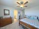 Bright bedroom featuring a comfortable bed, dresser, and a view into the ensuite bathroom, providing a peaceful retreat at 322 S Soledad Ct, Casa Grande, AZ 85194
