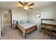 Bright bedroom featuring a comfortable bed, study desk, and neutral decor, perfect for relaxation and productivity at 322 S Soledad Ct, Casa Grande, AZ 85194