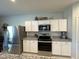 Kitchen area with white cabinets, granite countertops, and stainless steel appliances at 322 S Soledad Ct, Casa Grande, AZ 85194