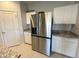 Close up on kitchen area featuring a stainless steel refrigerator and white cabinets at 322 S Soledad Ct, Casa Grande, AZ 85194