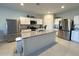 Bright kitchen with stainless steel appliances, an island, and granite countertops at 322 S Soledad Ct, Casa Grande, AZ 85194