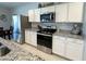 Well-lit kitchen features stainless steel appliances and white cabinetry at 322 S Soledad Ct, Casa Grande, AZ 85194