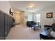Bright living room with neutral tones, wall accents, carpet flooring, and comfortable seating arrangement at 322 S Soledad Ct, Casa Grande, AZ 85194