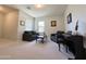 Inviting living room with neutral carpet, comfortable seating, and a piano creating a cozy gathering space at 322 S Soledad Ct, Casa Grande, AZ 85194