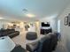 Spacious living room with leather seating, kitchen and dining area access at 322 S Soledad Ct, Casa Grande, AZ 85194