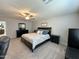 Comfortable main bedroom with a ceiling fan, dresser, and nightstands at 322 S Soledad Ct, Casa Grande, AZ 85194