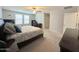 Spacious main bedroom featuring a ceiling fan, plush carpet, and natural light from large windows at 322 S Soledad Ct, Casa Grande, AZ 85194