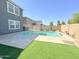 Backyard view of a private swimming pool and artificial grass at 322 S Soledad Ct, Casa Grande, AZ 85194