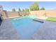 Sparkling backyard pool with a waterfall feature, perfect for relaxation and entertaining guests at 322 S Soledad Ct, Casa Grande, AZ 85194