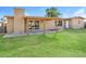 Spacious backyard featuring a covered patio, well-maintained lawn, and a block fence at 4062 W Eva St, Phoenix, AZ 85051