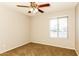Neutral bedroom featuring a ceiling fan, cozy carpet, and a window that provides natural light at 4062 W Eva St, Phoenix, AZ 85051