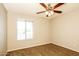 Cozy bedroom featuring carpet flooring, neutral paint, a ceiling fan, and a sunny window at 4062 W Eva St, Phoenix, AZ 85051