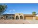 Charming single-level home featuring desert landscaping and a welcoming arched entryway, plus an attached two-car garage at 4062 W Eva St, Phoenix, AZ 85051