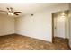 Open living room featuring tile floors leading to the front door and equipped with a ceiling fan at 4062 W Eva St, Phoenix, AZ 85051