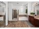 Bright bathroom with tile floors, glass shower, soaking tub, and dual sink vanity at 4221 S Fireside Ct, Gilbert, AZ 85297