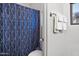 Bathroom features a blue and white patterned shower curtain and white towels at 4221 S Fireside Ct, Gilbert, AZ 85297