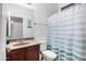 Bathroom with vanity, mirror, toilet, and shower with blue and white striped shower curtain at 4221 S Fireside Ct, Gilbert, AZ 85297