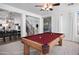 Game room features a wooden pool table, carpet flooring and is adjacent to the kitchen at 4221 S Fireside Ct, Gilbert, AZ 85297
