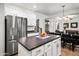 Bright kitchen with stainless steel fridge, white cabinetry, and center island facing dining area at 4221 S Fireside Ct, Gilbert, AZ 85297