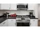 Modern kitchen with stainless steel appliances, white cabinets and dark countertops at 4221 S Fireside Ct, Gilbert, AZ 85297