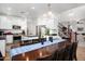 Kitchen features stainless steel appliances, a central island, and an adjacent dining area with seating for ten at 4221 S Fireside Ct, Gilbert, AZ 85297