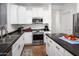 Modern kitchen with white cabinets, stainless steel appliances, and dark countertops at 4221 S Fireside Ct, Gilbert, AZ 85297