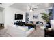 Comfortable living room with a ceiling fan, plush sofas, a dark coffee table and bright decor at 4221 S Fireside Ct, Gilbert, AZ 85297