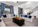 Inviting living room featuring plush sofas, large windows, high ceilings, and stylish curtains at 4221 S Fireside Ct, Gilbert, AZ 85297