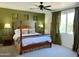 Serene bedroom with a four-poster bed, natural light, and stylish decor at 4221 S Fireside Ct, Gilbert, AZ 85297