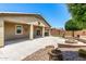 An expansive backyard with a covered patio, ample seating, and lush green foliage at 42519 W Centennial Ct, Maricopa, AZ 85138