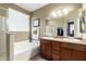 Bright bathroom featuring a double sink vanity, bathtub, and separate shower at 42519 W Centennial Ct, Maricopa, AZ 85138